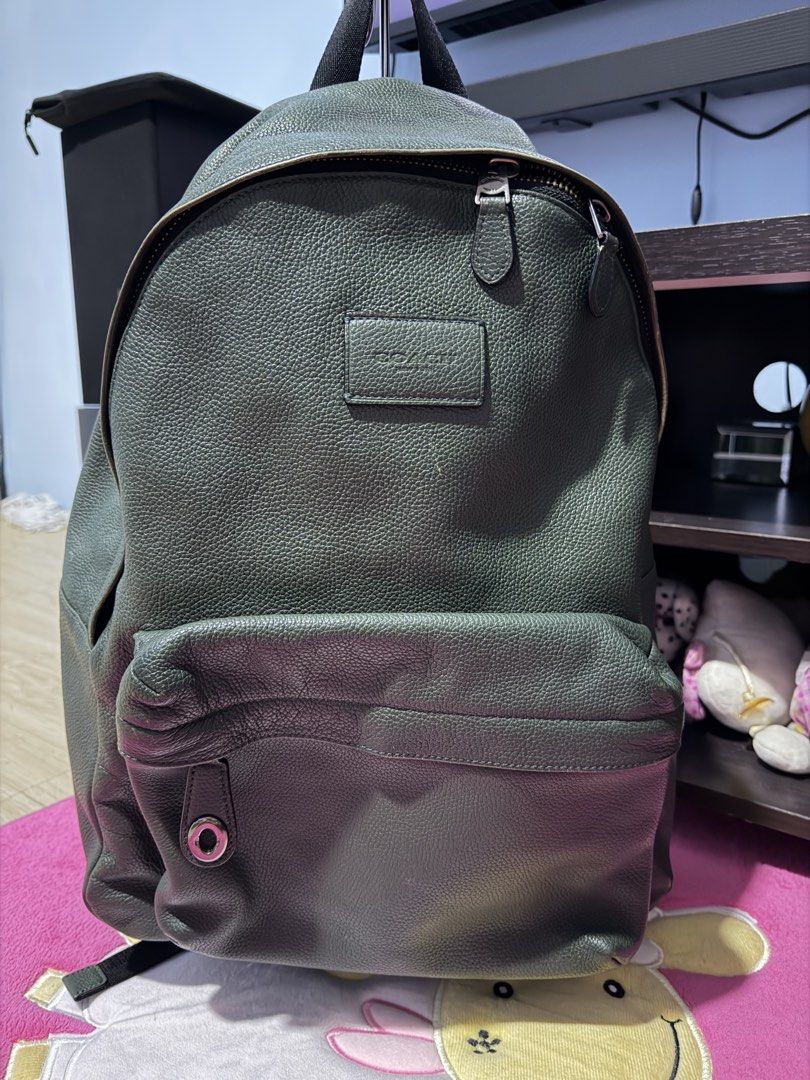 Coach Green Leather Backpack (Category: Backpacks) located in Manila. Submitted by dapixphot28865 (Listing ID 1471224055, Image 1). Description: - Brand: Coach - Material: Premium pebbled leather in dark green - Storage: Large main compartment with top zip closure & front zipped pocket - Details: Debossed Coach logo patch and stylish round metal detail - Straps: Sturdy black top handle and adjustable shoulder straps - Condition: Great daily compa