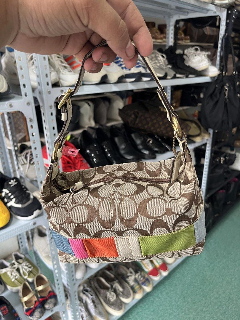 Coach Signature C Multi Color Patchwork Small Shoulder Bag (Category: Luxury Bags & Wallets) located in Manila. Submitted by christian048 (Listing ID 1471170046, Image 2). Description: - Brand: Coach - Style: Small shoulder bag - Material: Signature C canvas with white leather strap and brass hardware - Design: Multicolor patchwork stripe along the bottom edge - Interior: Vibrant hot pink lining with creed patch (A0768-40540) - Closure: Zipper cl