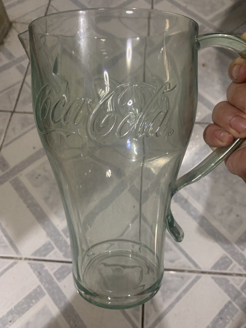 Coca-Cola Glass Pitcher Jug (Category: Pitchers & Dispensers) located in Antipolo. Submitted by cebb888 (Listing ID 1471153320, Image 1). Description: - Authentic Coca-Cola clear glass pitcher - Features classic embossed logo details - Sturdy side handle and convenient pouring spout - Compact size: stands about 7 inches tall - Heavy and durable glass construction - Clean interior, sparkling, and ready to use - Perfect for daily use or serving gue