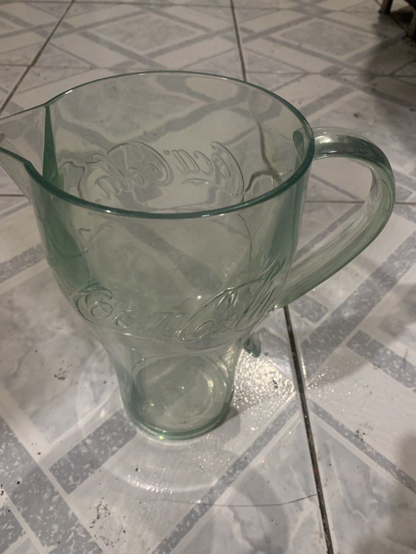 Coca-Cola Glass Pitcher Jug (Category: Pitchers & Dispensers) located in Antipolo. Submitted by cebb888 (Listing ID 1471153320, Image 3). Description: - Authentic Coca-Cola clear glass pitcher - Features classic embossed logo details - Sturdy side handle and convenient pouring spout - Compact size: stands about 7 inches tall - Heavy and durable glass construction - Clean interior, sparkling, and ready to use - Perfect for daily use or serving gue