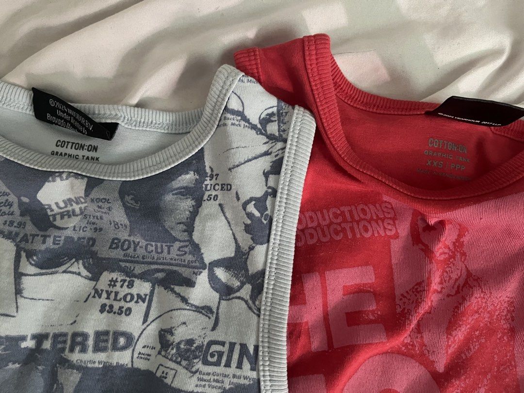 Cotton On Graphic Tank Tops Bundle Set (Category: Sleeveless) located in Santa Rosa. Submitted by astral97s (Listing ID 1471121696, Image 2). Description: - Brand: Cotton On - Size: XXS for the pink tank and XS for the blue one - Items: 2 graphic tank tops (Light Blue Vintage Newspaper Print & Bright Red The Who Band Graphic) - Bundle deal: Selling both together - wore only 3 times - rfs: out of style - if payo: can get 799.