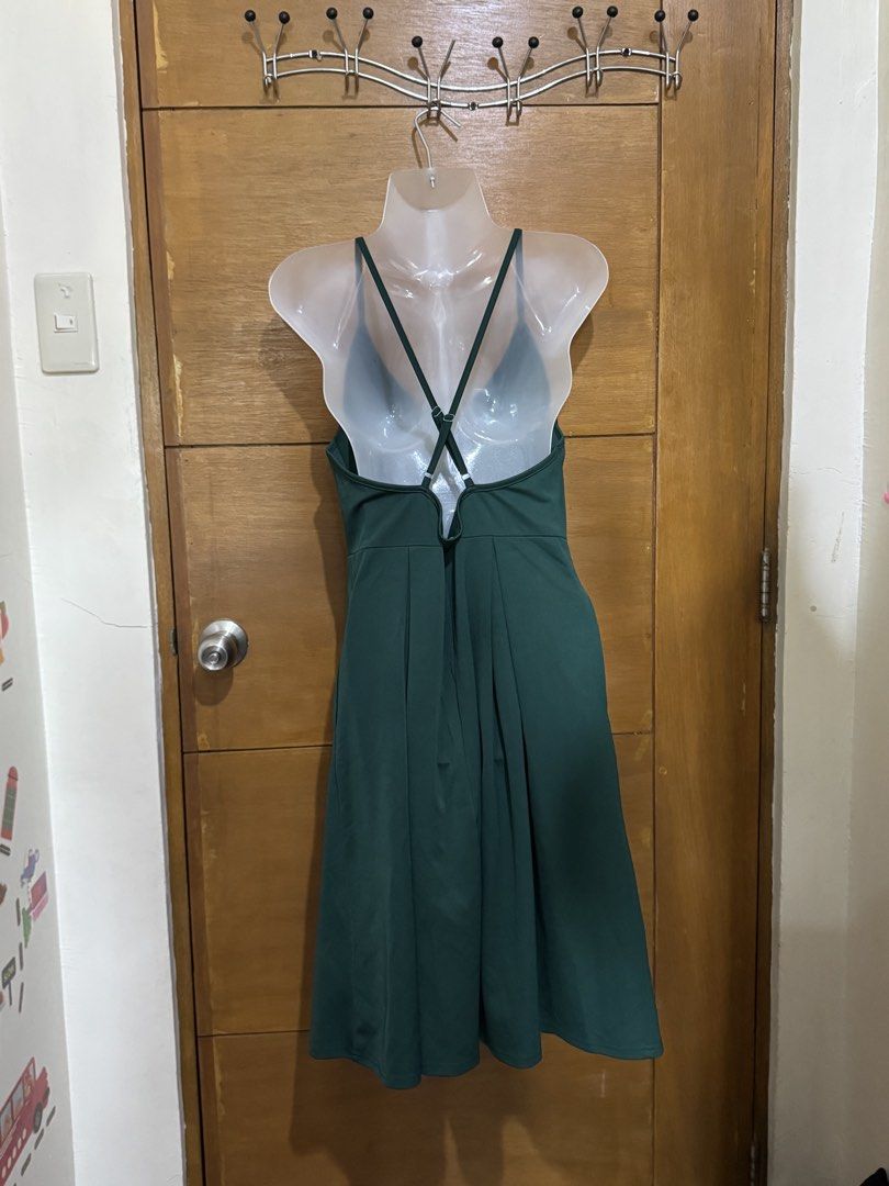 Dark Green Spaghetti Strap Midi Dress (Category: Dresses) located in Antipolo. Submitted by winsell (Listing ID 1471186112, Image 3). Description: - Color: Dark green - Style: Sleeveless midi dress with V-neckline - Back: Crossed adjustable straps - Details: Pleated skirt section, neat stitching - Length: Knee-length - Condition: Clean, ready to wear - Versatility: Great for casual or semi-formal occasions.