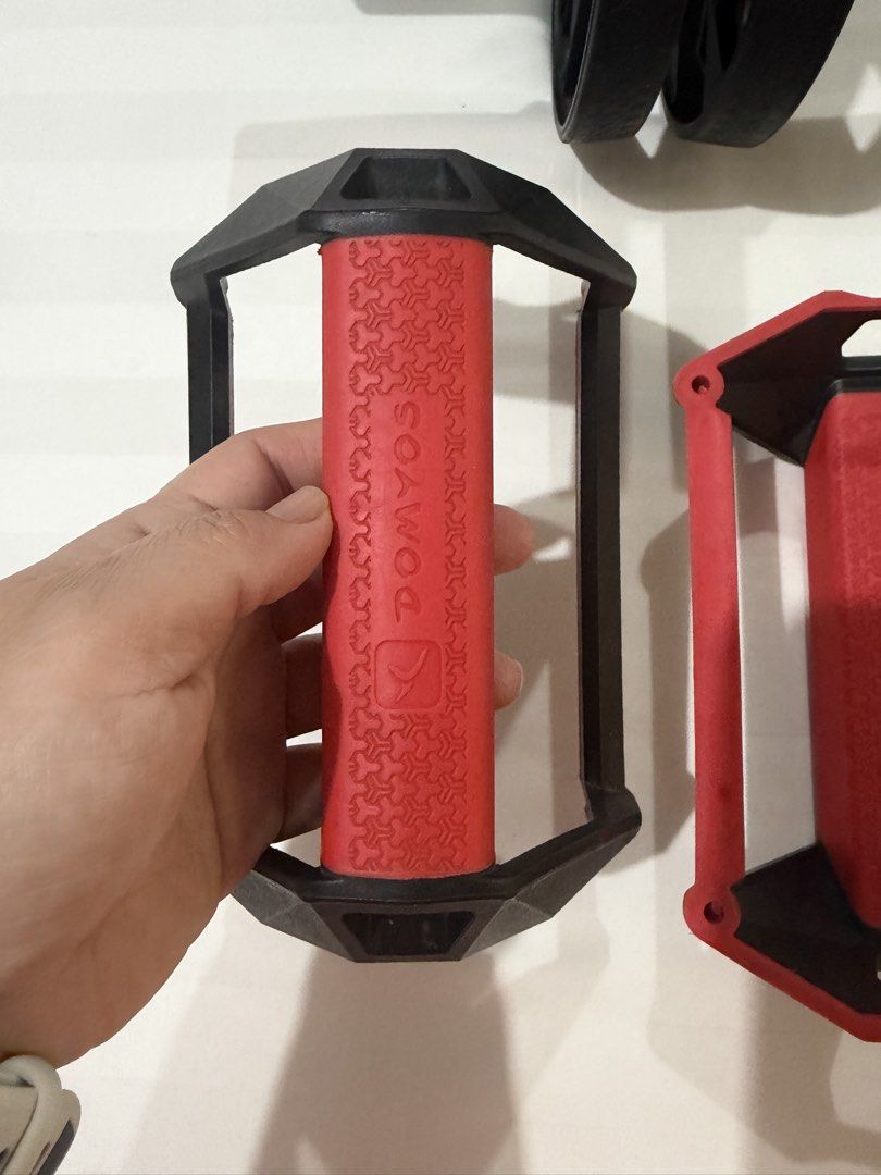 Decathlon Domyos Ab Roller and Push Up Bars SET (Category: Toning & Stretching Accessories) located in Marikina City. Submitted by kscanlas12 (Listing ID 1471179174, Image 3). Description: - Brand: Domyos - Includes: Dual ab wheel roller and two push-up handles - Color/Design: Black wheels with textured grips and red handles featuring a geometric pattern and Domyos logo - Ideal for: Home core workouts and upper body training - Condition: Minimal 