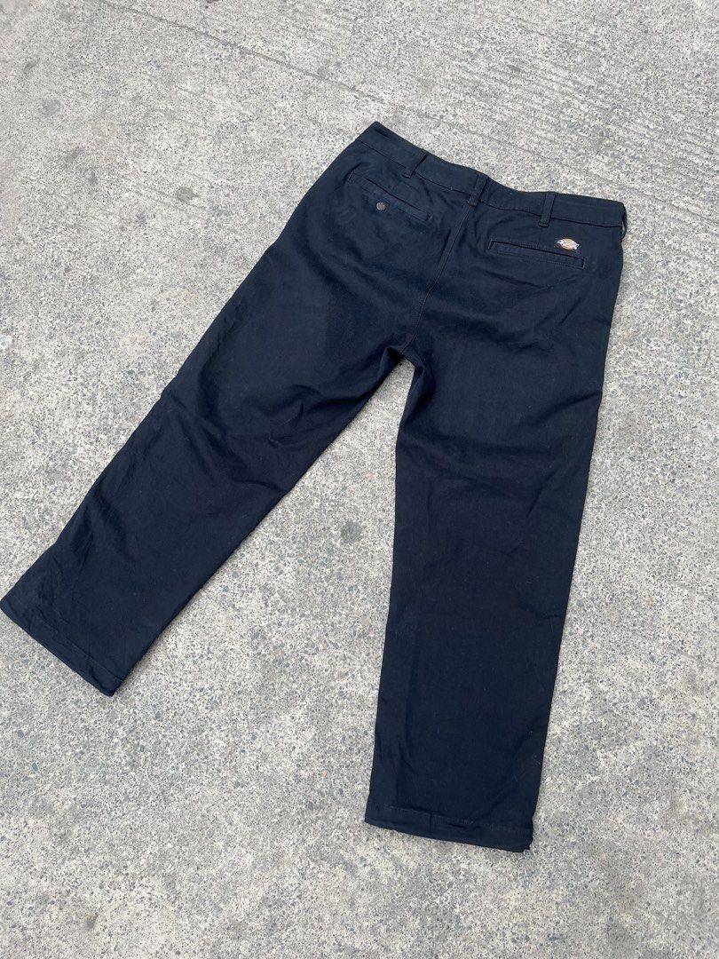 Dickies 1922 Black Cargo Pants (Category: Trousers) located in Manila. Submitted by donthriftph. (Listing ID 1471196945, Image 2). Description: - Brand: Dickies 1922 - Color: Solid black - Fit: Straight fit through the legs - Material: Heavy-duty, durable fabric - Pockets: Multiple utility pockets with snap button flaps - Details: Branded inner waistband with logo print, embroidered logo on left cargo pocket, button fly, and branded metal buttons