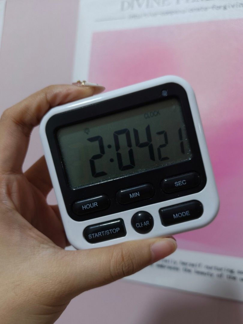 Digital Kitchen Timer and Clock with Magnetic Back (Category: Clocks) located in Manila. Submitted by lynnn_. (Listing ID 1471167933, Image 1). Description: White and black digital timer with a clear LCD screen. Has hour, minute, second, start/stop, clear, and mode buttons. Battery compartment and magnetic pad on the back. Stands up or sticks to metal surfaces easily. Works great for cooking, studying, or workouts..
