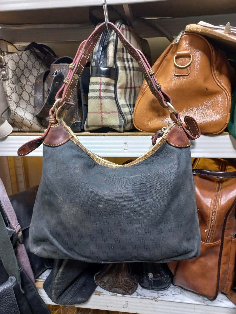 Dooney & Bourke Monogram Hobo Shoulder Bag (Category: Luxury Bags & Wallets) located in Quezon City. Submitted by dei03_diz (Listing ID 1471161489, Image 1). Description: - Style: Black fabric hobo bag with repeated DB monogram print - Straps & Trim: Brown leather adjustable shoulder strap and trim with yellow contrast stitching - Hardware & Closure: Gold-tone hardware with secure top zip closure - Interior: Bright pink fabric lining with multipl