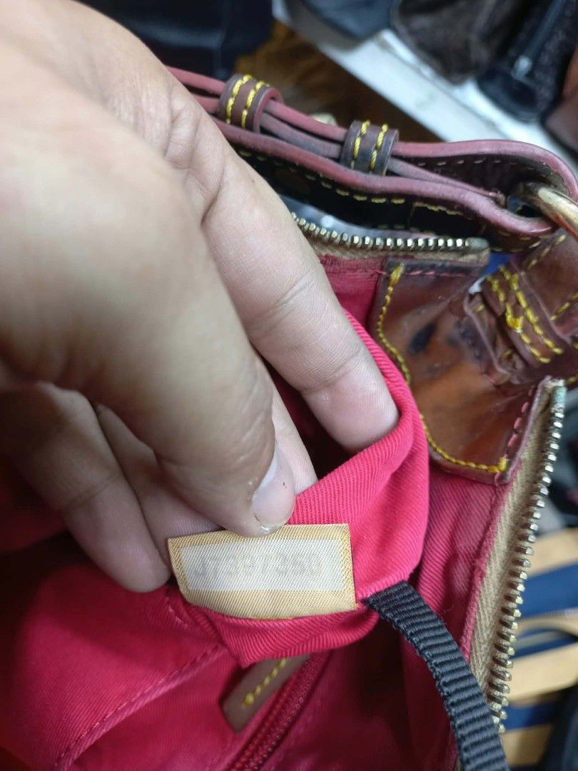 Dooney & Bourke Monogram Hobo Shoulder Bag (Category: Luxury Bags & Wallets) located in Quezon City. Submitted by dei03_diz (Listing ID 1471161489, Image 3). Description: - Style: Black fabric hobo bag with repeated DB monogram print - Straps & Trim: Brown leather adjustable shoulder strap and trim with yellow contrast stitching - Hardware & Closure: Gold-tone hardware with secure top zip closure - Interior: Bright pink fabric lining with multipl