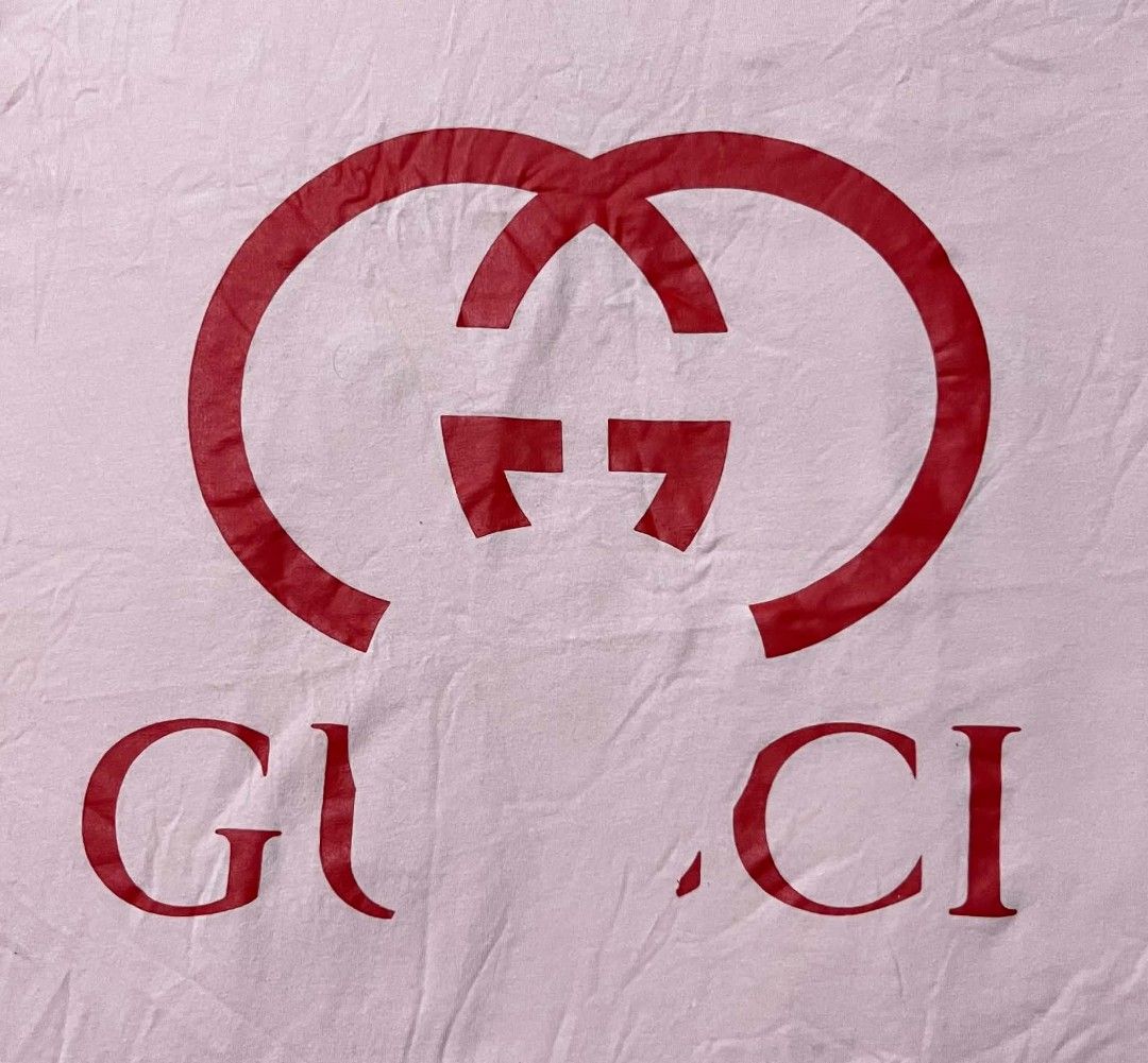 Doraemon x Gucci Pink T-shirt (Category: Shirts) located in Taguig. Submitted by 22nd_street_thrift (Listing ID 1471164722, Image 2). Description: Collaboration tee from Doraemon and Gucci. Pink cotton fabric with large red intertwined G logo printed on the chest. Special green collar tag featuring Doraemon artwork and Fujiko Pro copyright text. Made in Italy label attached below the neck tag. Long interior care label included..