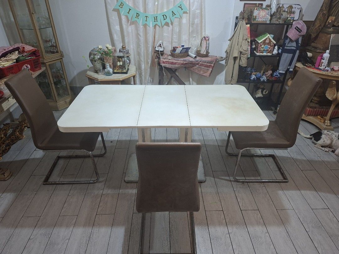 Extendable Dining Table with 4 Brown Leatherette Chairs Set (Category: Tables & Sets) located in Quezon City. Submitted by feliboykins (Listing ID 1471212549, Image 1). Description: Complete dining set featuring a white extendable rectangular dining table paired with 4 modern brown leather upholstered chairs. • Table Mechanism: Super easy to expand and collapse. Uses a simple, soft push-and-pull system with a single central unlock tab underneath.