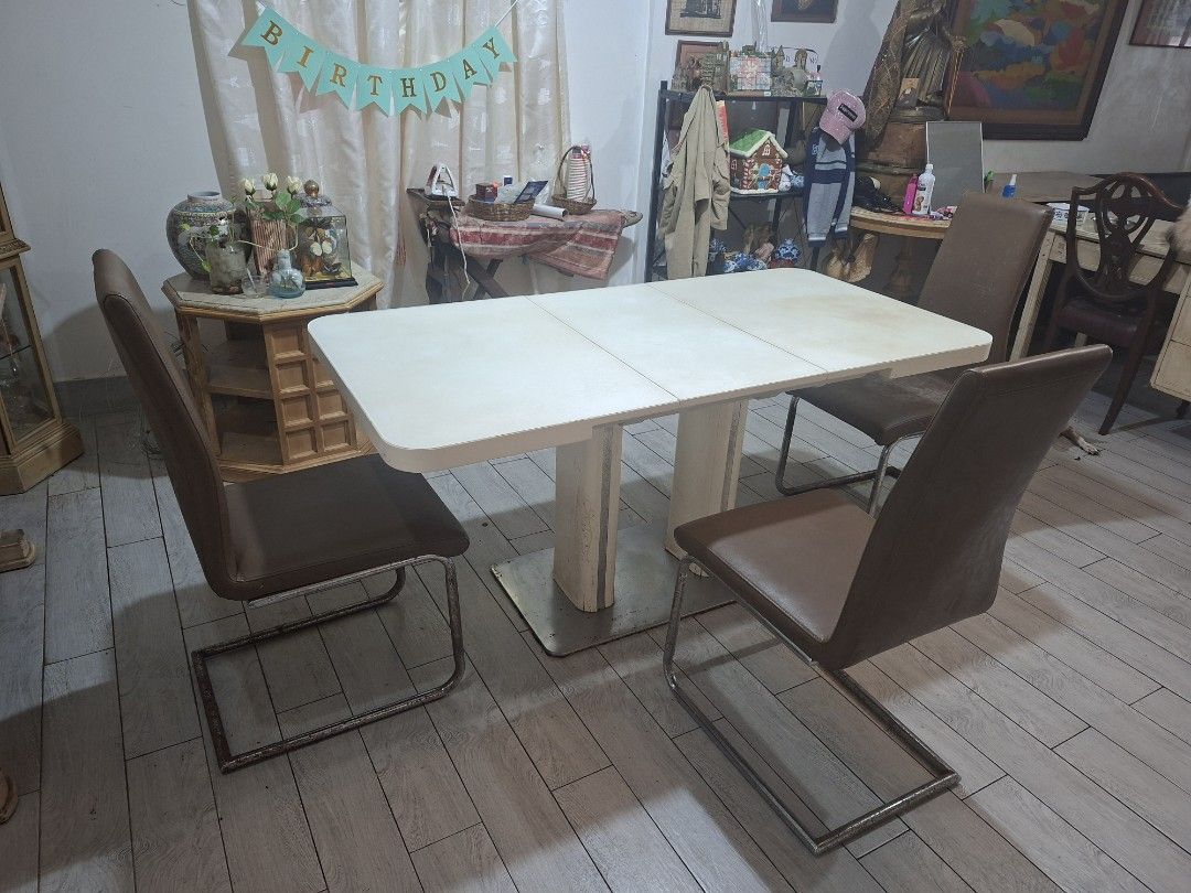 Extendable Dining Table with 4 Brown Leatherette Chairs Set (Category: Tables & Sets) located in Quezon City. Submitted by feliboykins (Listing ID 1471212549, Image 3). Description: Complete dining set featuring a white extendable rectangular dining table paired with 4 modern brown leather upholstered chairs. • Table Mechanism: Super easy to expand and collapse. Uses a simple, soft push-and-pull system with a single central unlock tab underneath.