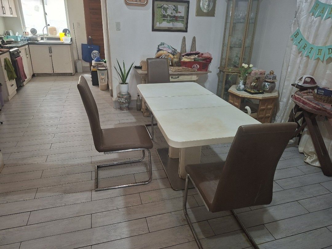 Extendable Dining Table with 4 Brown Leatherette Chairs Set (Category: Tables & Sets) located in Quezon City. Submitted by feliboykins (Listing ID 1471212549, Image 2). Description: Complete dining set featuring a white extendable rectangular dining table paired with 4 modern brown leather upholstered chairs. • Table Mechanism: Super easy to expand and collapse. Uses a simple, soft push-and-pull system with a single central unlock tab underneath.