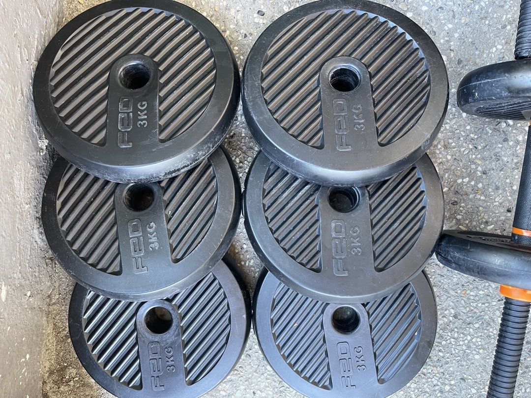 FED Adjustable Dumbbell Set with Weight Plates (Category: Weights & Dumbbells) located in Paranaque City. Submitted by cheskadejon (Listing ID 1471189365, Image 3). Description: - Brand: FED adjustable dumbbells - Features: Black ribbed weight plates with vibrant orange spinlock collars - Inclusions: Two dumbbell bars and multiple 3kg and 2.5kg plates - Condition: Minor surface scuffs from use, but fully functional and ready for your home gym - I