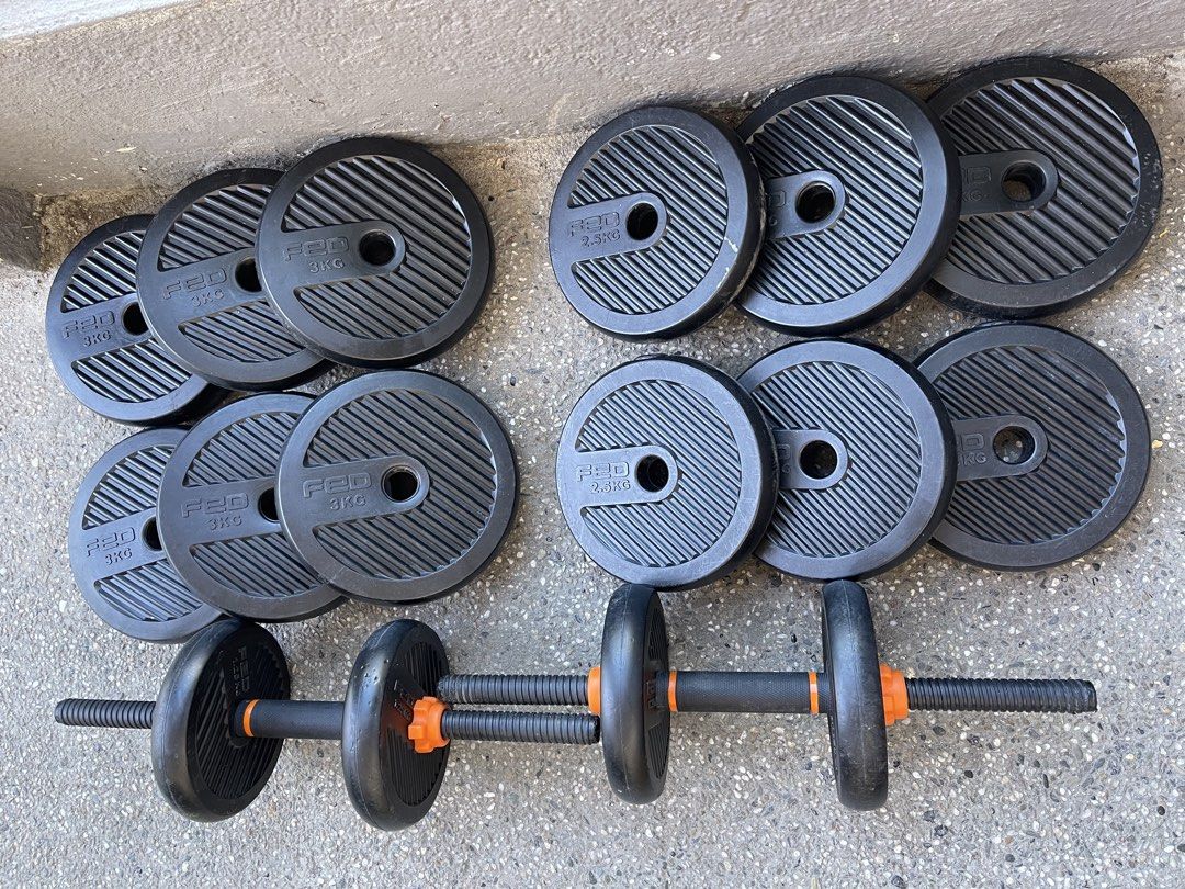 FED Adjustable Dumbbell Set with Weight Plates (Category: Weights & Dumbbells) located in Paranaque City. Submitted by cheskadejon (Listing ID 1471189365, Image 2). Description: - Brand: FED adjustable dumbbells - Features: Black ribbed weight plates with vibrant orange spinlock collars - Inclusions: Two dumbbell bars and multiple 3kg and 2.5kg plates - Condition: Minor surface scuffs from use, but fully functional and ready for your home gym - I