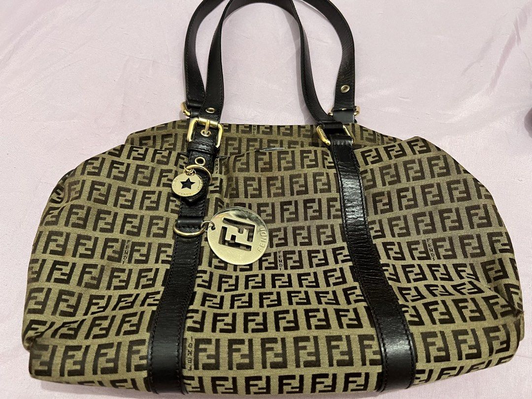 Fendi Zucca Print Canvas Shoulder Bag (Category: Luxury Bags & Wallets) located in Manila. Submitted by czaaay (Listing ID 1471124542, Image 1). Description: - Authentic Fendi shoulder bag in iconic brown Zucca canvas monogram - Dark brown leather handles and front strap details - Elegant gold-tone hardware featuring Fendi logo disc and star charms - Secure top zipper closure - Spacious interior ideal for everyday essentials - Condition: Excellen