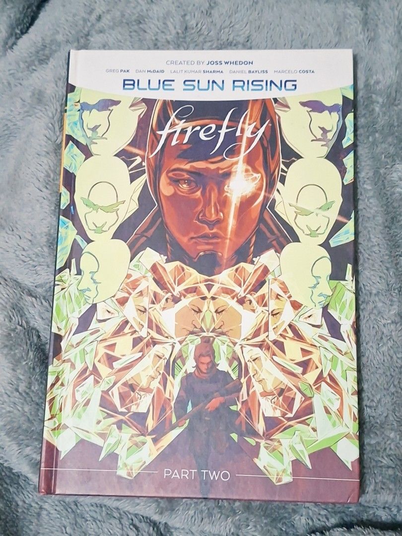 Firefly Blue Sun Rising Part Two Graphic Novel (Category: Comics & Manga) located in Pasay City. Submitted by riririju (Listing ID 1471213271, Image 1). Description: - Title: Firefly: Blue Sun Rising Part Two Hardcover Graphic Novel - Creators: Joss Whedon (Creator), Greg Pak (Writer), Dan McDaid, Lalit Kumar Sharma, Daniel Bayliss, and Marcelo Costa (Artists) - Condition: Great shape, clean pages, solid binding, and crisp cover art - Ideal for: 