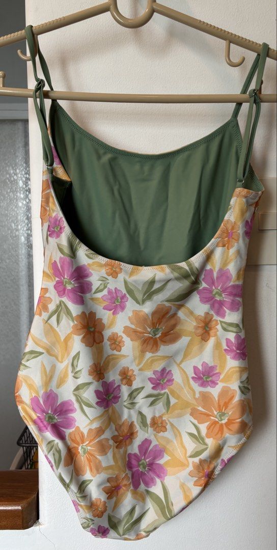 Floral One-Piece Swimsuit (Category: Bikinis & Swimsuits) located in Muntinlupa City. Submitted by danir918 (Listing ID 1471186589, Image 2). Description: - Cream floral one-piece swimsuit with pink, orange, and yellow flowers - Adjustable spaghetti straps with metal sliders for a custom fit - Scoop neckline and low scoop back design - store price: 2,000+ .