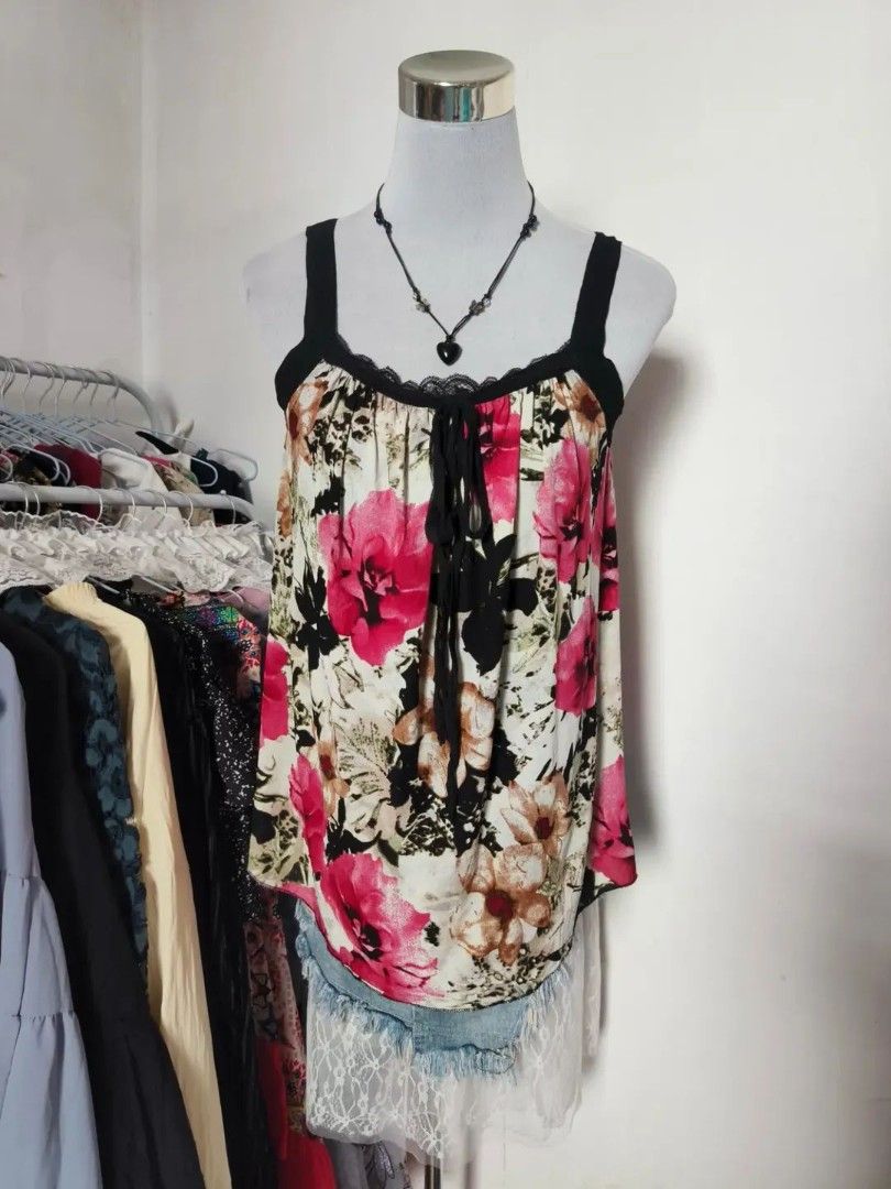 Floral Print Tank Top with Ruffle Hem (Category: Sleeveless) located in Quezon City. Submitted by alluring.avenue (Listing ID 1471280723, Image 2). Description: - Design: Vibrant pink and brown floral pattern on a black and white background - M-L - Neckline & Straps: Square neckline with black lace trim and black tank straps - Details: Cute tie-string at the chest and a layered ruffled white fabric hem - Material: Lightweight, breathable fabric i