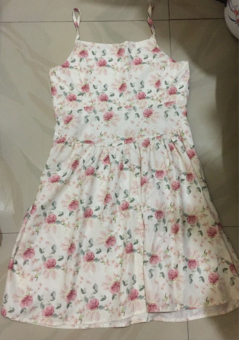 Floral spaghetti strap summer dress (Category: Dresses) located in Marikina City. Submitted by sunflora.thrift (Listing ID 1471278458, Image 1). Description: - Style: White summer midi dress with pink roses and green leaves - Neckline: Square neckline with thin adjustable straps - Fit: Fitted bodice with a gathered skirt - Fabric: Lightweight and breathable for warm days - Condition: Excellent, clean with no stains or tears.