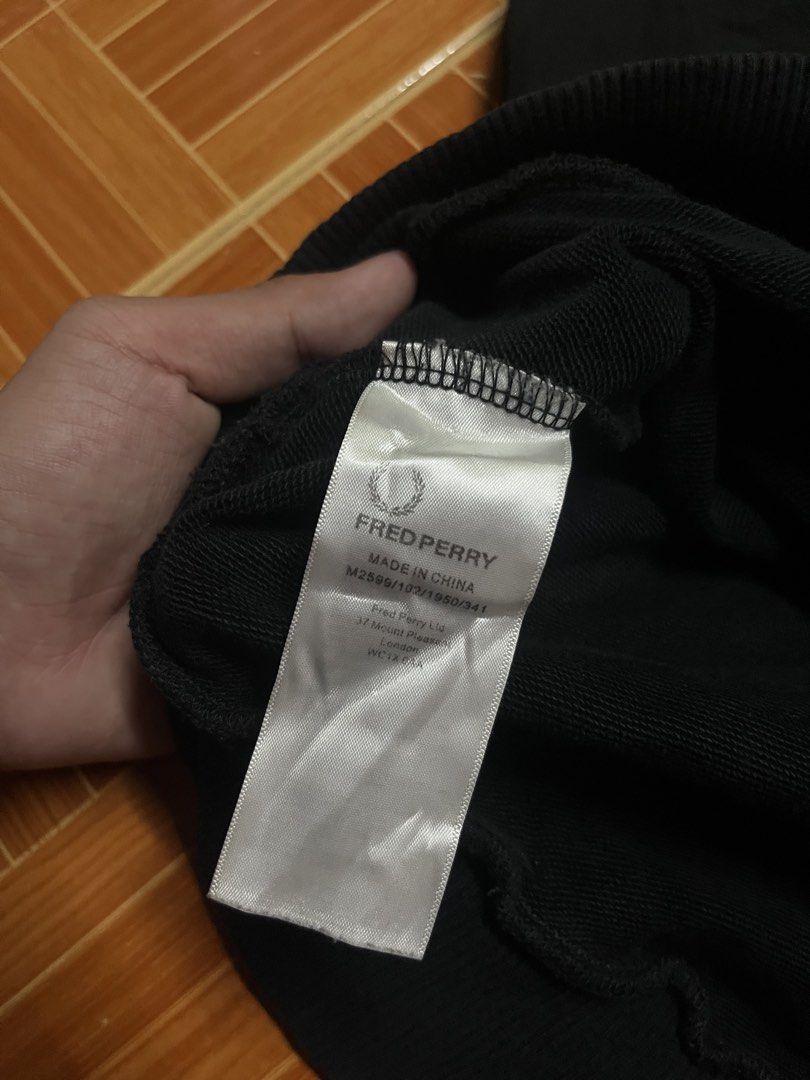 Fred Perry Black Crewneck Sweatshirt Size L (Category: Coats, Jackets and Outerwear) located in Manila. Submitted by jlfamiliar69452 (Listing ID 1471146749, Image 3). Description: - Brand: Fred Perry - Item: Crewneck Sweatshirt - Color: Black with white embroidered laurel wreath logo - Size: L (Tag on collar) - Details: Striped ribbed cuffs and hem, classic pullover style - Origin: Made in China - Style Code: M2599.