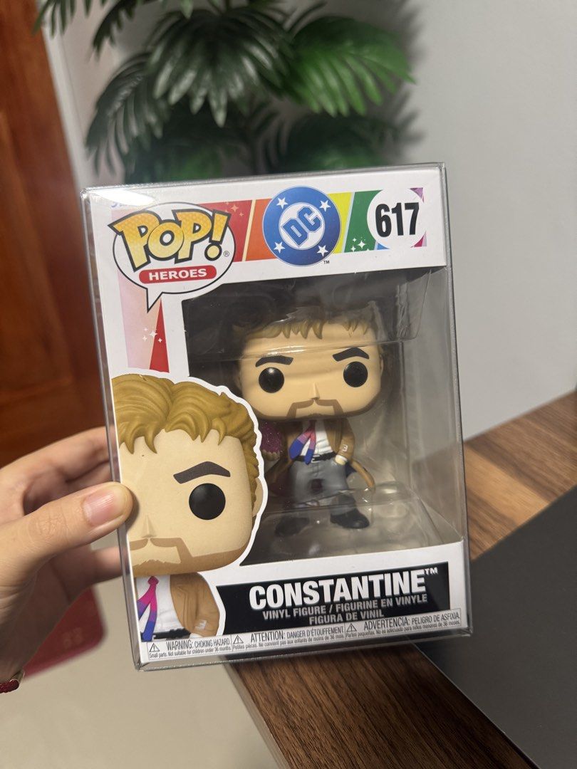Funko Pop DC Heroes Constantine Vinyl Figure 617 (Category: Figurines & Statues) located in Bacoor. Submitted by shenelleandrea (Listing ID 1471256769, Image 1). Description: - With Boss Protector - Very Good Box Condition John Constantine from DC Heroes, vinyl figure number 617. Holding a purple crystal, wearing his signature tan trench coat and a pride tie. Comes safely stored inside a clear protective hard case. Box has the DC branding and rai