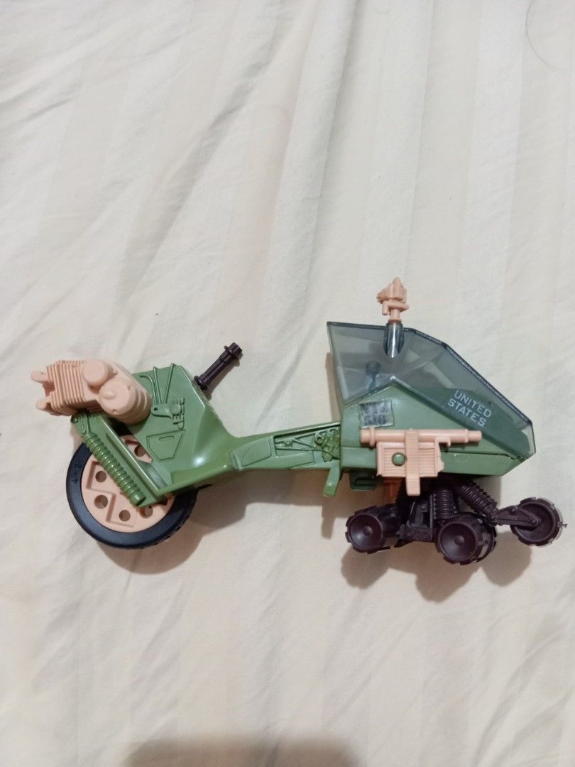 Gi Joe LCV Recon Sled (Category: Vehicle & Diecast Models) located in Manila. Submitted by johnhunte48138 (Listing ID 1471192209, Image 2). Description: - Green plastic military vehicle toy - Features 'United States' lettering and clear cockpit windshield - Includes brown gun turret and tan engine details - Designed with a single front wheel and rear track cluster - Perfect collectible piece for military vehicle fans - Condition: Brand new/Good a