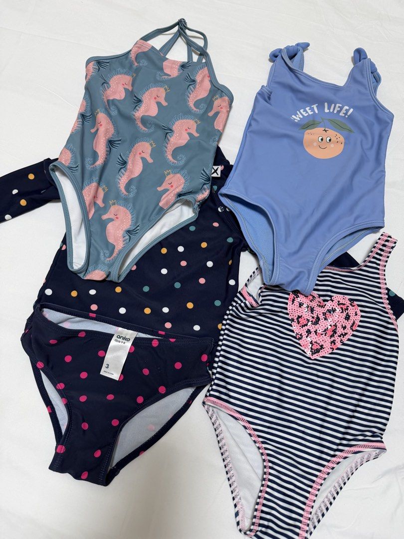 Girls Swimwear Bundle (Category: Babies & Kids Fashion) located in Mandaluyong City. Submitted by tinamella (Listing ID 1471254401, Image 2). Description: - Brand: Anko - Quantity: Bundle of 4 girls swimsuits - Includes: Polka dot long sleeve rash guard set, blue seahorse one-piece, blue peach print one-piece, and navy striped one-piece with pink sequin heart - Sizes: Ranges from height 84cm / 12kg up to size 3 - Condition: Tags attached on sever