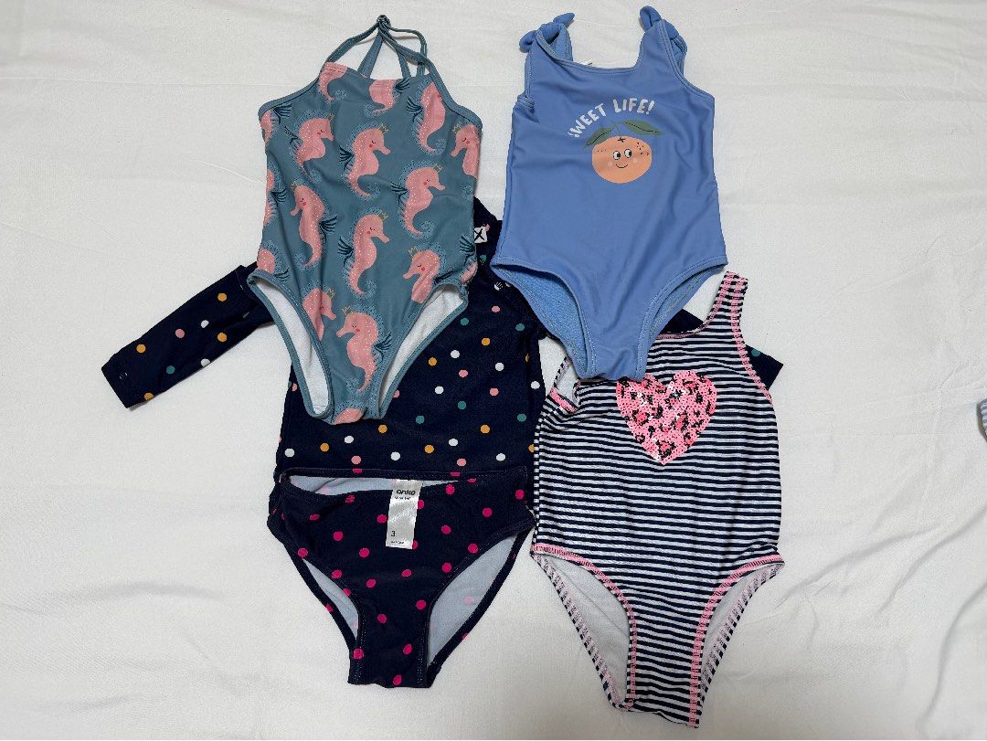 Girls Swimwear Bundle (Category: Babies & Kids Fashion) located in Mandaluyong City. Submitted by tinamella (Listing ID 1471254401, Image 1). Description: - Brand: Anko - Quantity: Bundle of 4 girls swimsuits - Includes: Polka dot long sleeve rash guard set, blue seahorse one-piece, blue peach print one-piece, and navy striped one-piece with pink sequin heart - Sizes: Ranges from height 84cm / 12kg up to size 3 - Condition: Tags attached on sever