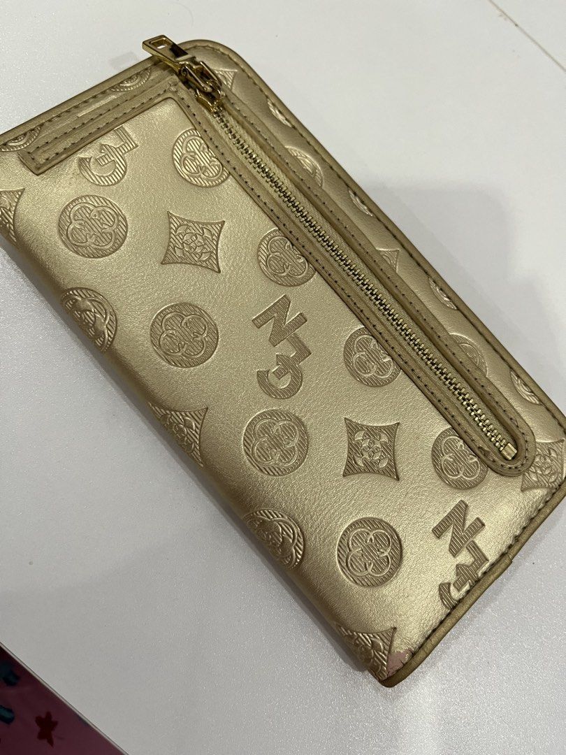 Gold patterned long wallet with multiple card slots and zipper pocket (Category: Wallets & Card holders) located in Rizal. Submitted by oncelove143 (Listing ID 1471142428, Image 2). Description: - Elegant gold wallet with an all-over embossed pattern - Secure front flap with snap button closure - Multiple card slots inside for organized storage - Convenient back zippered compartment for coins and small essentials - Chic gold-tone hardware on the 