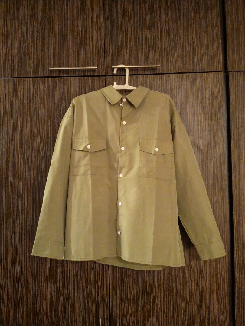 Green button-up shirt with front pockets size M (Category: Shirts) located in Las Pinas. Submitted by sam_twin_d (Listing ID 1471127018, Image 1). Description: - Brand: New with original store tag attached - Size: Medium (M) - Color: Solid olive-khaki / green - Style: Relaxed fit, long-sleeve button-down - Features: Dual chest pockets and contrasting white buttons - Condition: Fresh and unworn - Versatility: Easy to match for everyday casual outf