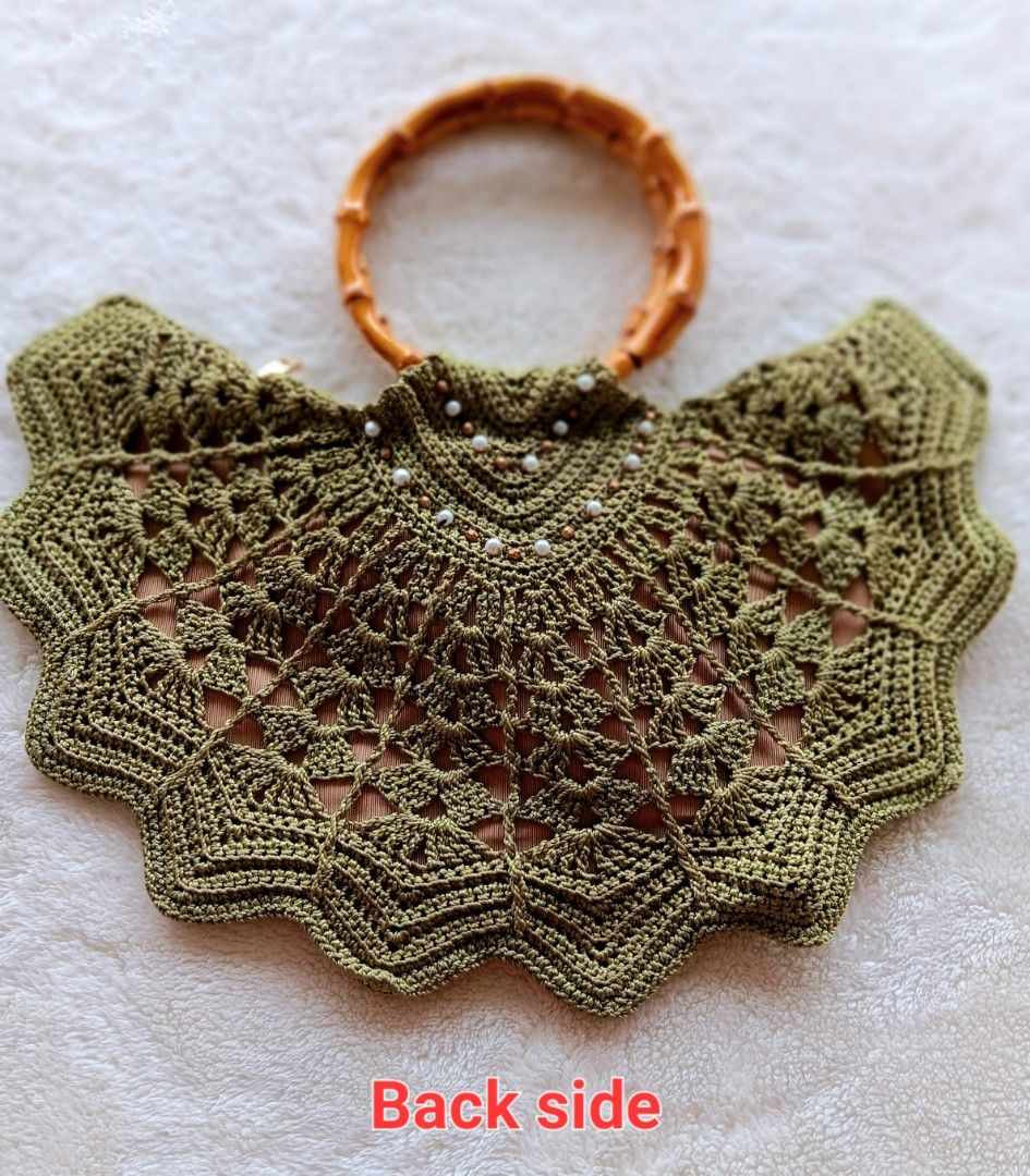 Green Crochet Handbag Bamboo Handle Shell Beaded Statement Bag (Category: Shoulder Bags) located in Pateros City. Submitted by sphinxvillanueva (Listing ID 1471216967, Image 3). Description: - Handcrafted olive green crochet handbag in a stylish boho summer design - Features a sturdy round bamboo top handle and secure zippered interior - Embellished front flap with wooden beads, mother-of-pearl leaves, and a large shell statement pendant - Beauti