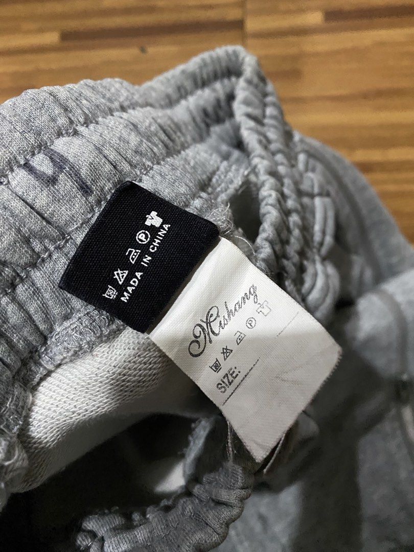 Grey Jogger Sweatpants (Category: Joggers) located in Manila. Submitted by ellieeeeee0293929 (Listing ID 1471124004, Image 2). Description: - Brand: Mishang - Color: Grey - Material: Comfortable cotton blend - Fit/Style: Casual loungewear with elastic waistband and matching drawstrings - Features: Functional multiple pockets and trendy zippers on both ankles - Origin: Made in China.