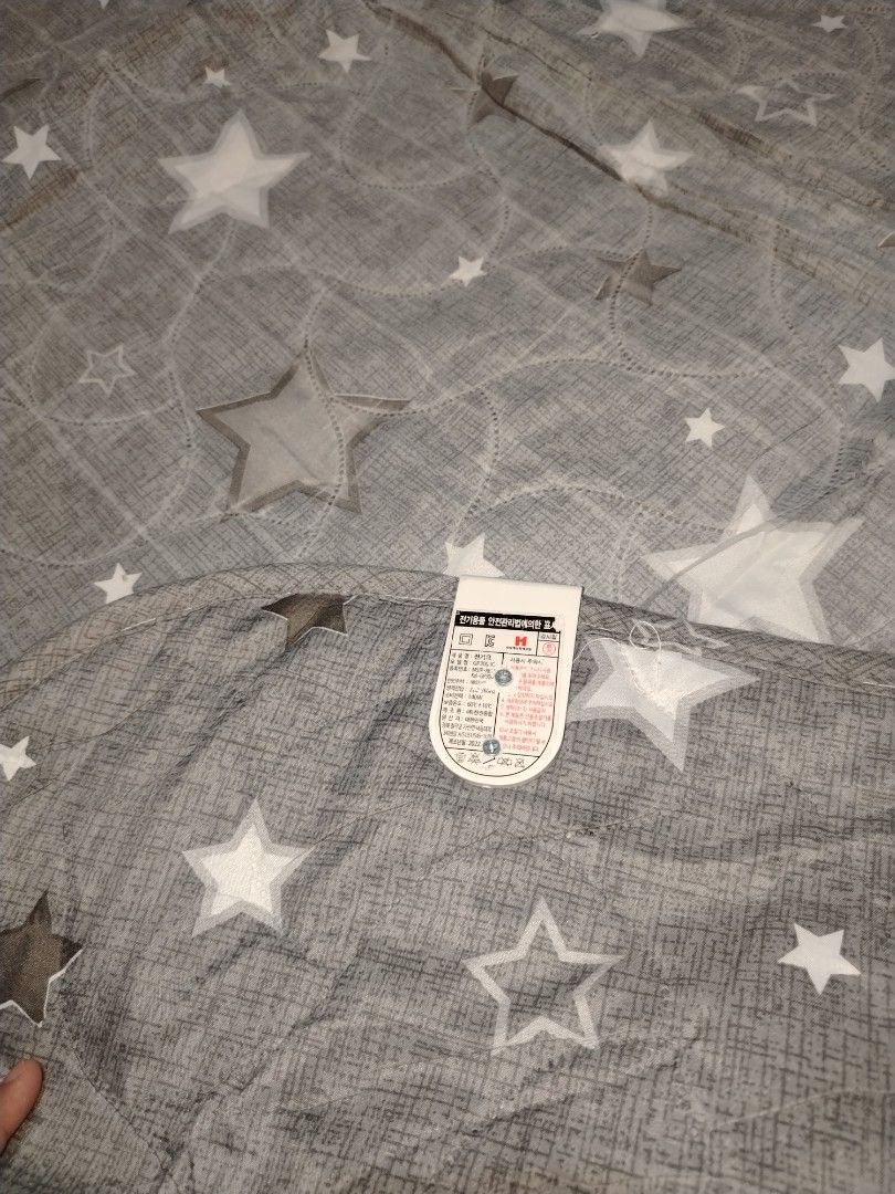 Grey Star Pattern Electric Blanket Mat (Category: Bedding & Towels) located in Manila. Submitted by mimachelleukay (Listing ID 1471245267, Image 2). Description: Issue :No cable - Color & Design: Grey with all-over white star pattern - Size: Generous 2.2 x 1.6 meters - Power: 140W for efficient heating - Material: Soft and comfortable quilted fabric - Safety: Standard safety certification label attached - Perfect for keeping warm during chilly ni