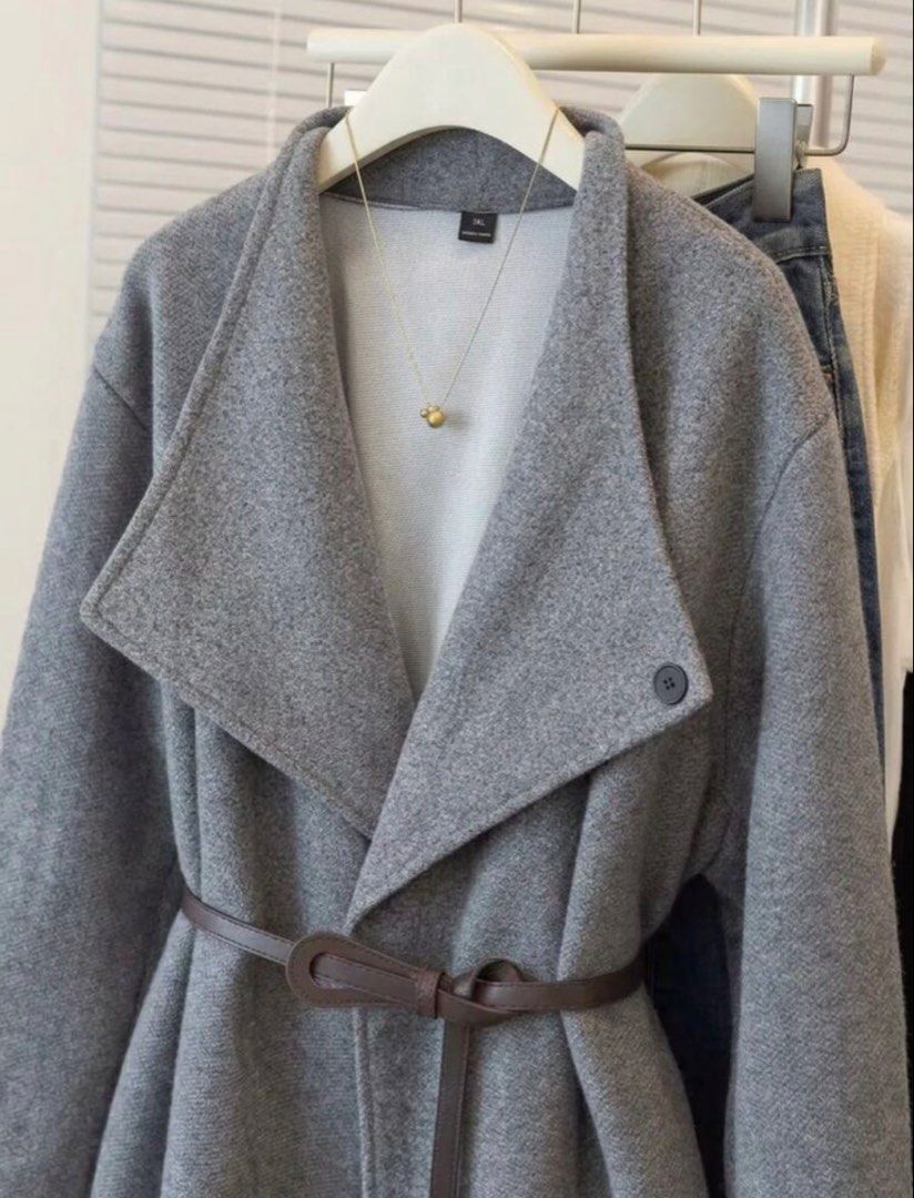 Grey Woolen Coat Jacket With Belt (Category: Coats, Jackets and Outerwear) located in Cagayan de Oro. Submitted by tinp17 (Listing ID 1471164682, Image 2). Description: - Color: Grey - Material: Soft textured wool-blend outer with smooth inner lining - Design: Open front with a chic wide lapel collar and long sleeves - Detail: Includes a thin brown faux leather waist belt for a flattering fit - Styling: Perfect for layering over basic tops and sw