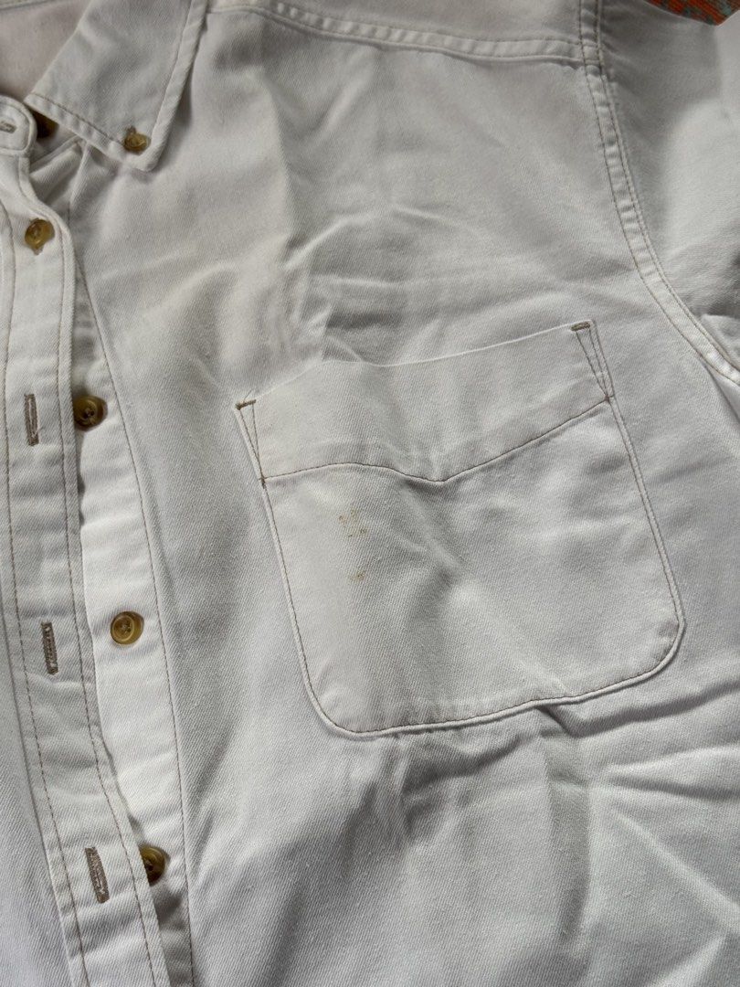GU White Short Sleeve Button-Down Shirt (Category: Shirts) located in Quezon City. Submitted by mymelodylvr (Listing ID 1471286538, Image 2). Description: - Brand: GU - Color: Classic White - Material: 100% Cotton - Details: Short sleeves, button-down collar, single chest pocket, curved hem - Condition: Good overall, but please note small stains on the front pocket - Style: Casual basic top, easy to pair with denim or shorts.