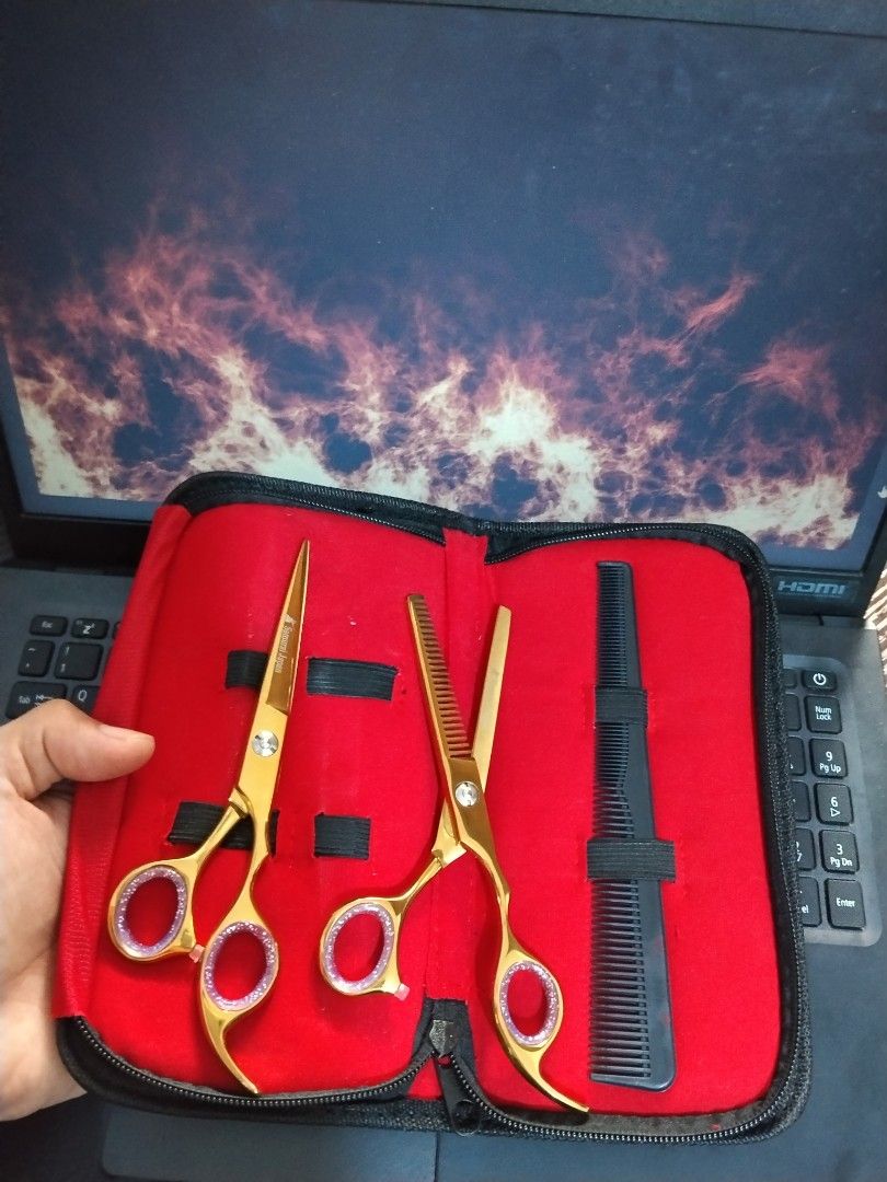 Hair Cutting Scissors Thinning Shears Set with Case (Category: Hair) located in Manila. Submitted by junaid23 (Listing ID 1471174954, Image 3). Description: - Complete hair styling kit for home use or grooming practice - Includes straight scissors, thinning shears, and a black comb - Durable stainless steel construction with comfortable finger rings - Comes in a compact red zipped storage case for easy organization - Brand new and ready to use.