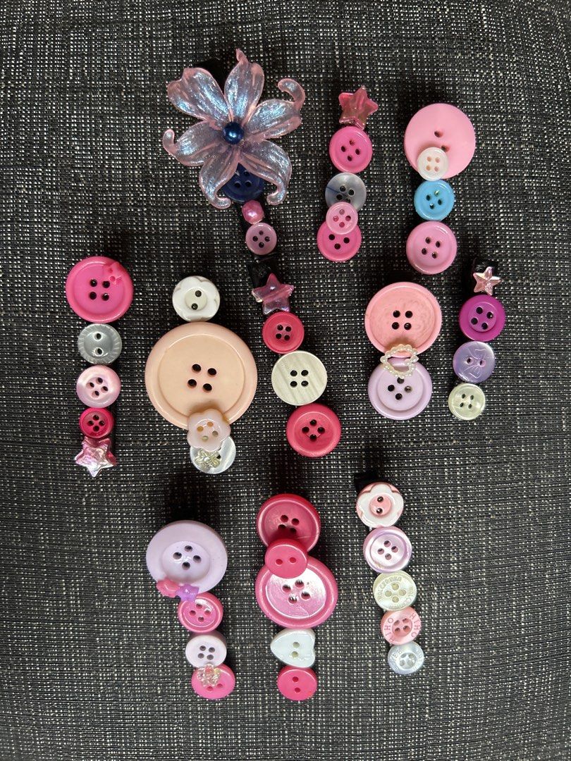 Handmade Button Hair Clips Pink Purple Set (Category: Hair Accessories) located in Manila. Submitted by ardol (Listing ID 1471149410, Image 1). Description: ₱10-15 each 120 BUNDLE - Handmade hair clip set featuring unique pink, purple, and white button designs - Includes playful styles like flower shapes, layered buttons, and star charms - Fitted with secure, durable clips on the back for all-day hold - Adds a fun, colorful, and quirky touch to a