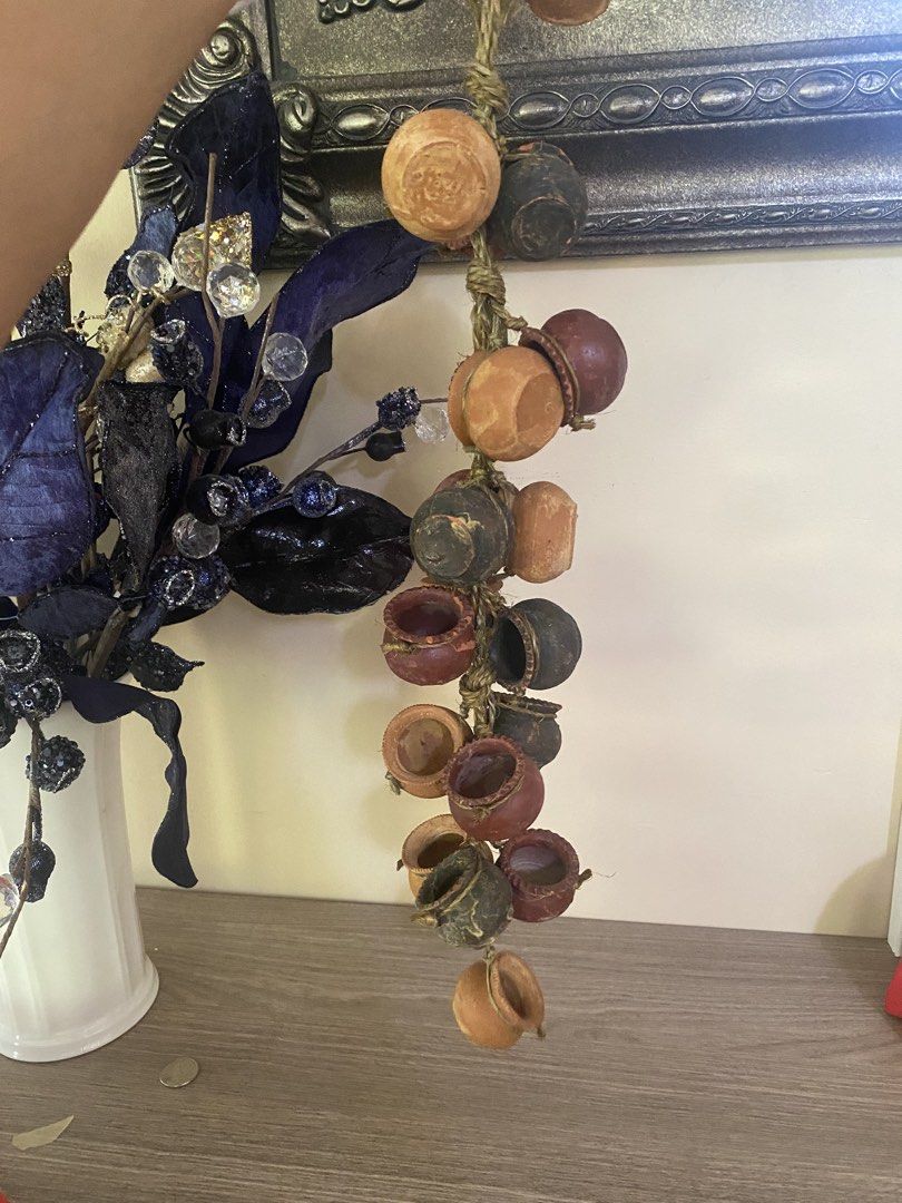 Hanging Garlic Ceramic and Miniature Pots Bundle Decor (Category: Wall Decor) located in Santa Rosa. Submitted by hoardqueensdeclutter (Listing ID 1471241616, Image 3). Description: - Set of 2 unique hanging decorative pieces for kitchen or dining room - Strand 1: Ceramic garlic bulbs in charming pink and white with a rustic rope loop - Strand 2: Miniature terracotta-style pots in mixed earthy tones tied with twine - Versatile display: Easily han