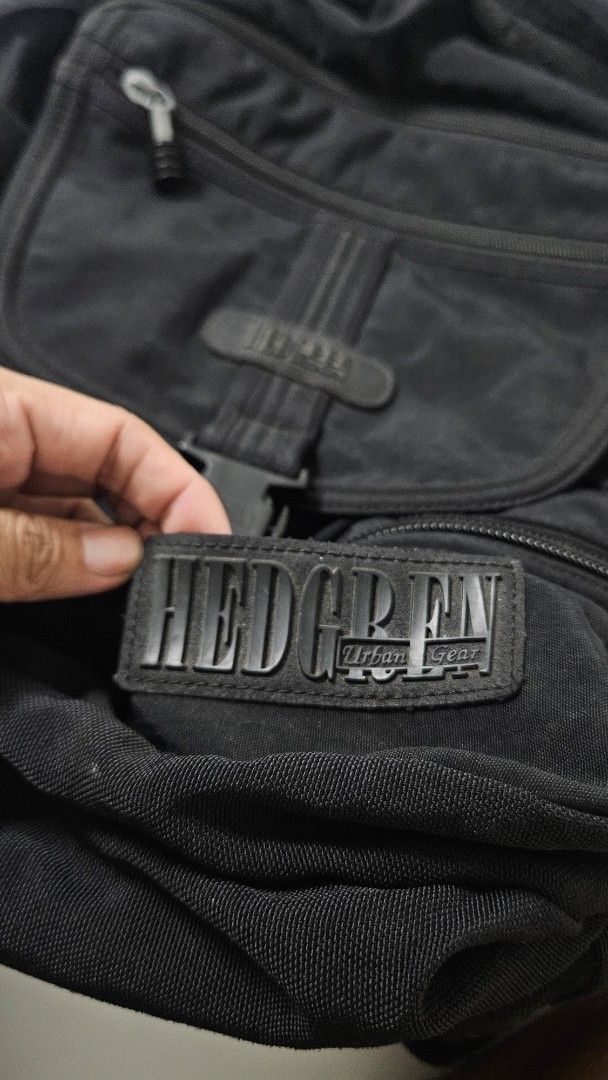 Hedgren Urban Gear Black Backpack E305592 (Category: Backpacks) located in Alfonso. Submitted by jbcamet (Listing ID 1471240832, Image 2). Description: - Brand: Hedgren Urban Gear - Color: Classic Black - Model Number: E305592 (stamped on metal plate) - Storage: Multiple exterior zip compartments and secure buckle front pocket - Comfort: Textured back panel with padded ergonomic shaping - Build: Durable fabric construction with heavy-duty zippers
