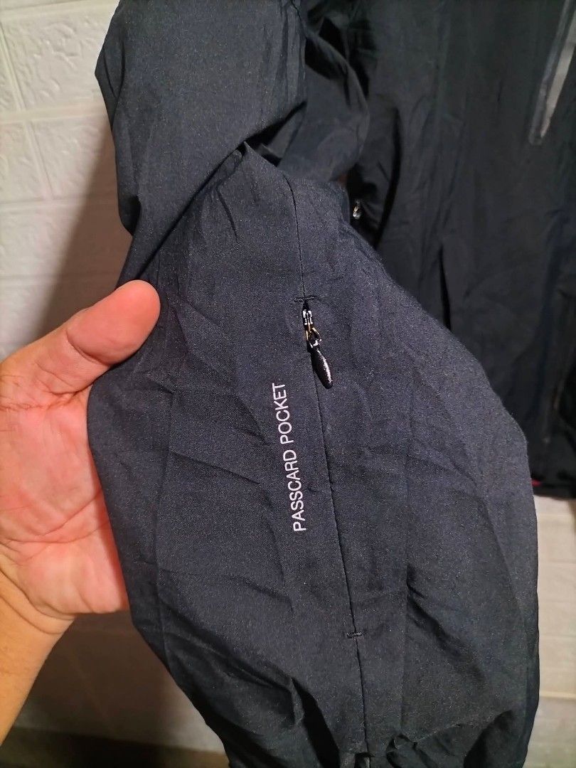 Helly Hansen Black H2Flow Waterproof Hooded Jacket Size 100 (Category: Coats, Jackets and Outerwear) located in Valencia. Submitted by cabisaythriftshop (Listing ID 1471225775, Image 2). Description: - Brand: Helly Hansen - Color: Black with olive green and black polka dot mesh lining - Size: 100 slim fit - Technology: Helly Tech Protection with H2Flow system for breathability and warmth regulation - Pockets: Waterproof chest pockets and a dedica