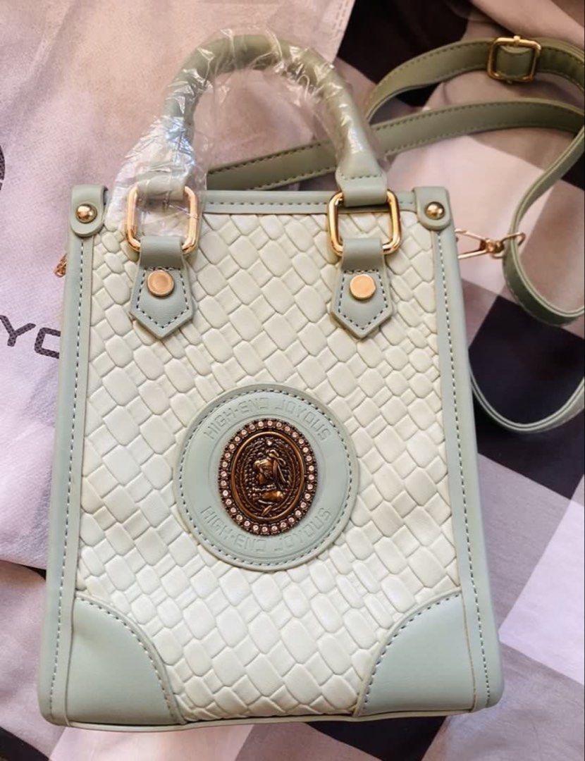 High-End Joyous Green Mini Tote Bag (Category: Tote Bags) located in Marikina City. Submitted by jessylady10 (Listing ID 1471269557, Image 1). Description: - Color/Style: Mint green mini tote bag with a trendy woven texture pattern and vintage-style metal emblem - Condition: Brand new, handles are still wrapped in original plastic - Features: Secure zipper top closure, compact size that easily fits a phone - Inclusions: Matching long adjustable s