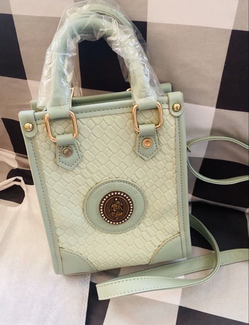 High-End Joyous Green Mini Tote Bag (Category: Tote Bags) located in Marikina City. Submitted by jessylady10 (Listing ID 1471269557, Image 3). Description: - Color/Style: Mint green mini tote bag with a trendy woven texture pattern and vintage-style metal emblem - Condition: Brand new, handles are still wrapped in original plastic - Features: Secure zipper top closure, compact size that easily fits a phone - Inclusions: Matching long adjustable s