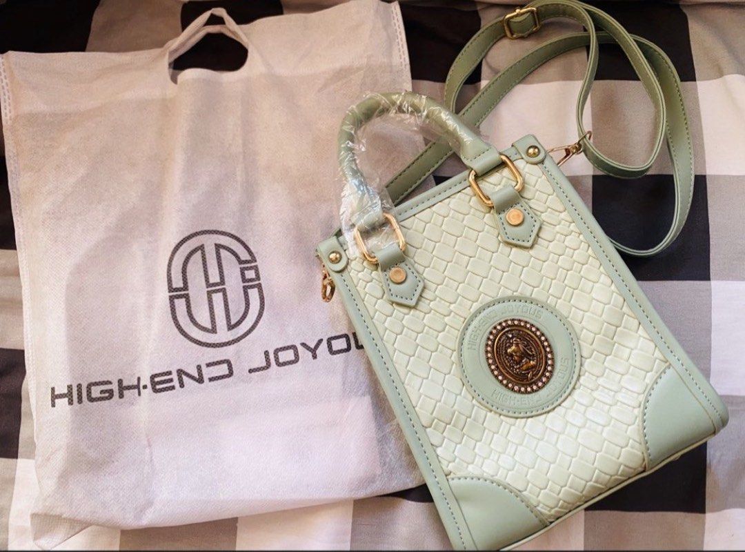 High-End Joyous Green Mini Tote Bag (Category: Tote Bags) located in Marikina City. Submitted by jessylady10 (Listing ID 1471269557, Image 2). Description: - Color/Style: Mint green mini tote bag with a trendy woven texture pattern and vintage-style metal emblem - Condition: Brand new, handles are still wrapped in original plastic - Features: Secure zipper top closure, compact size that easily fits a phone - Inclusions: Matching long adjustable s