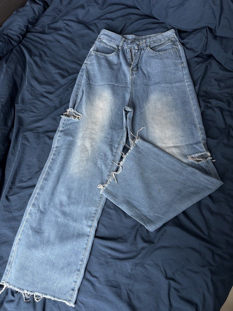 High-waisted wide-leg distressed blue jeans (Category: Jeans) located in Quezon City. Submitted by valeriorac74670 (Listing ID 1471182255, Image 1). Description: - Style: High-waisted wide-leg streetwear jeans - Wash: Mid wash with a cool faded effect on the front - Details: Distressed knees and trendy raw frayed hems - Fit: Fitted waist with button/zipper closure and a super comfy relaxed leg - Pockets: Deep, functional front pockets - Styling: 