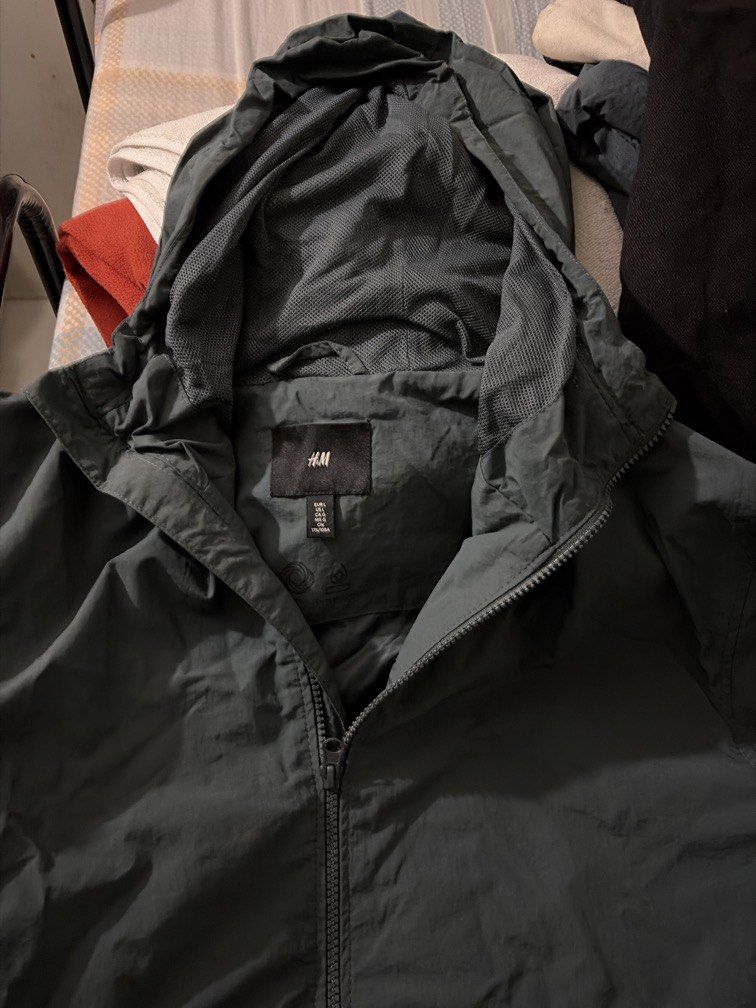 H&M Dark Green Hooded Windbreaker Jacket (Category: Coats, Jackets and Outerwear) located in Manila. Submitted by marccalderon (Listing ID 1471232678, Image 2). Description: - Brand/Model: H&M Dark Green Windbreaker - Size: L - Features: Built-in hood, breathable mesh lining, full zip front, and deep side pockets - Material: Lightweight and comfortable - Condition: Clean, well-kept, and ready to wear RFS: Decluterring. Lalamove only. .