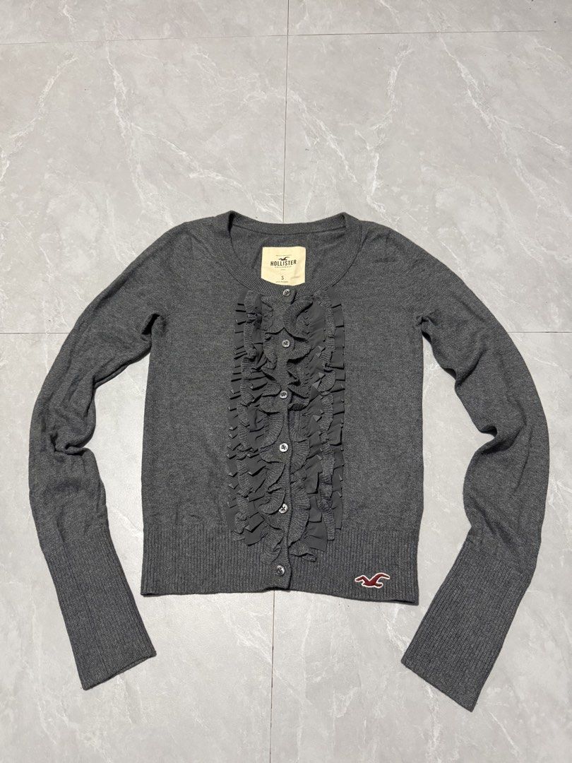 Hollister Ruffle Front Cardigan Sweater (Category: Longsleeves) located in Calumpit. Submitted by Essentiality (Listing ID 1471266726, Image 1). Description: Hollister Ruffle Front Cardigan Sweater 15x20.5 S on tag ₱1,500.