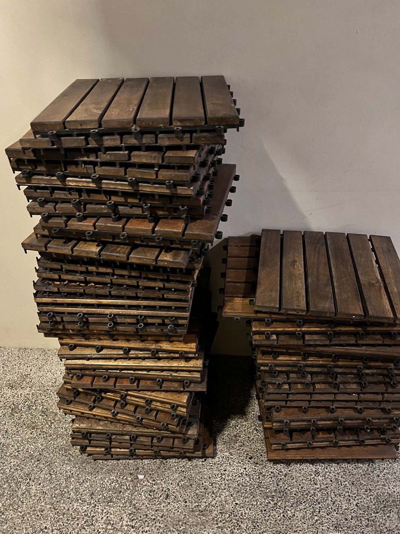 Interlocking Wooden Deck Tiles Outdoor Flooring (Category: Carpets, Mats & Flooring) located in Manila. Submitted by camzcastro70875 (Listing ID 1471274254, Image 2). Description: - Type: Wooden interlocking flooring tiles - Color: Dark brown wood slats with black plastic base - Features: Fast snap-together design, ideal for balconies, patios, and gardens - Condition: Normal wear from previous use - Availability: Plenty of pieces ready for pickup
