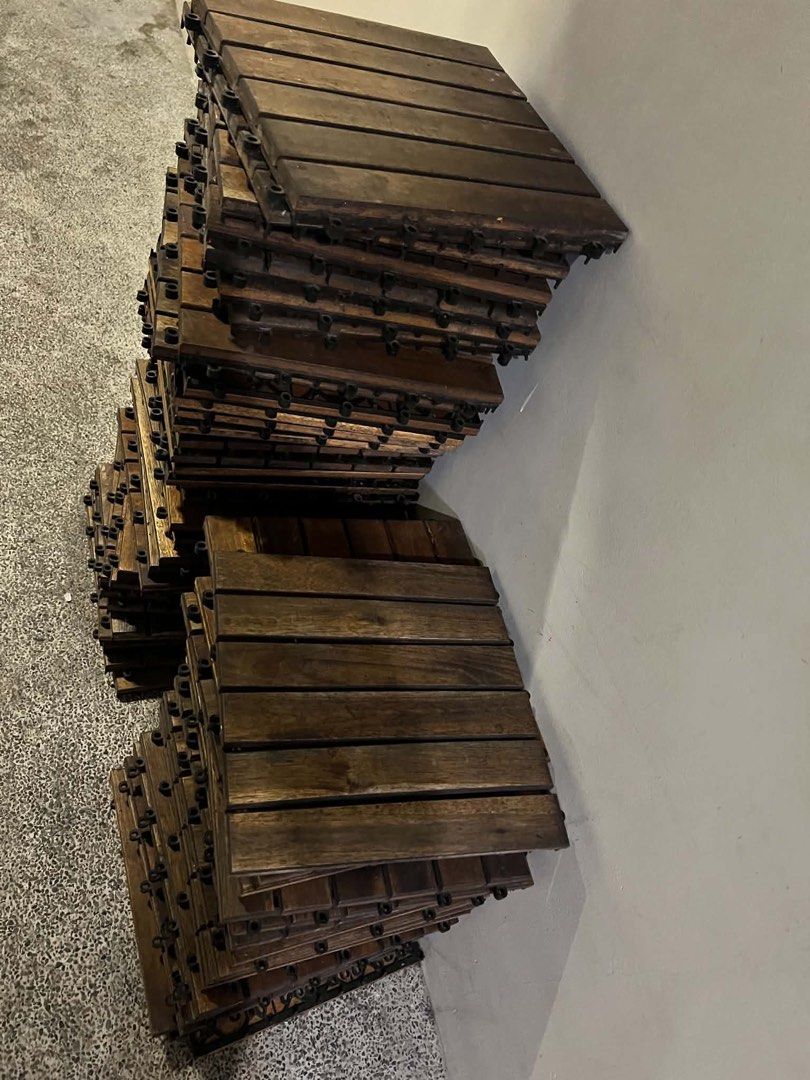 Interlocking Wooden Deck Tiles Outdoor Flooring (Category: Carpets, Mats & Flooring) located in Manila. Submitted by camzcastro70875 (Listing ID 1471274254, Image 1). Description: - Type: Wooden interlocking flooring tiles - Color: Dark brown wood slats with black plastic base - Features: Fast snap-together design, ideal for balconies, patios, and gardens - Condition: Normal wear from previous use - Availability: Plenty of pieces ready for pickup