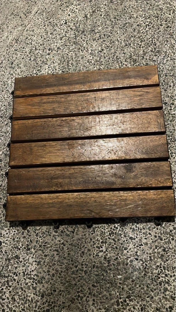Interlocking Wooden Deck Tiles Outdoor Flooring (Category: Carpets, Mats & Flooring) located in Manila. Submitted by camzcastro70875 (Listing ID 1471274254, Image 3). Description: - Type: Wooden interlocking flooring tiles - Color: Dark brown wood slats with black plastic base - Features: Fast snap-together design, ideal for balconies, patios, and gardens - Condition: Normal wear from previous use - Availability: Plenty of pieces ready for pickup