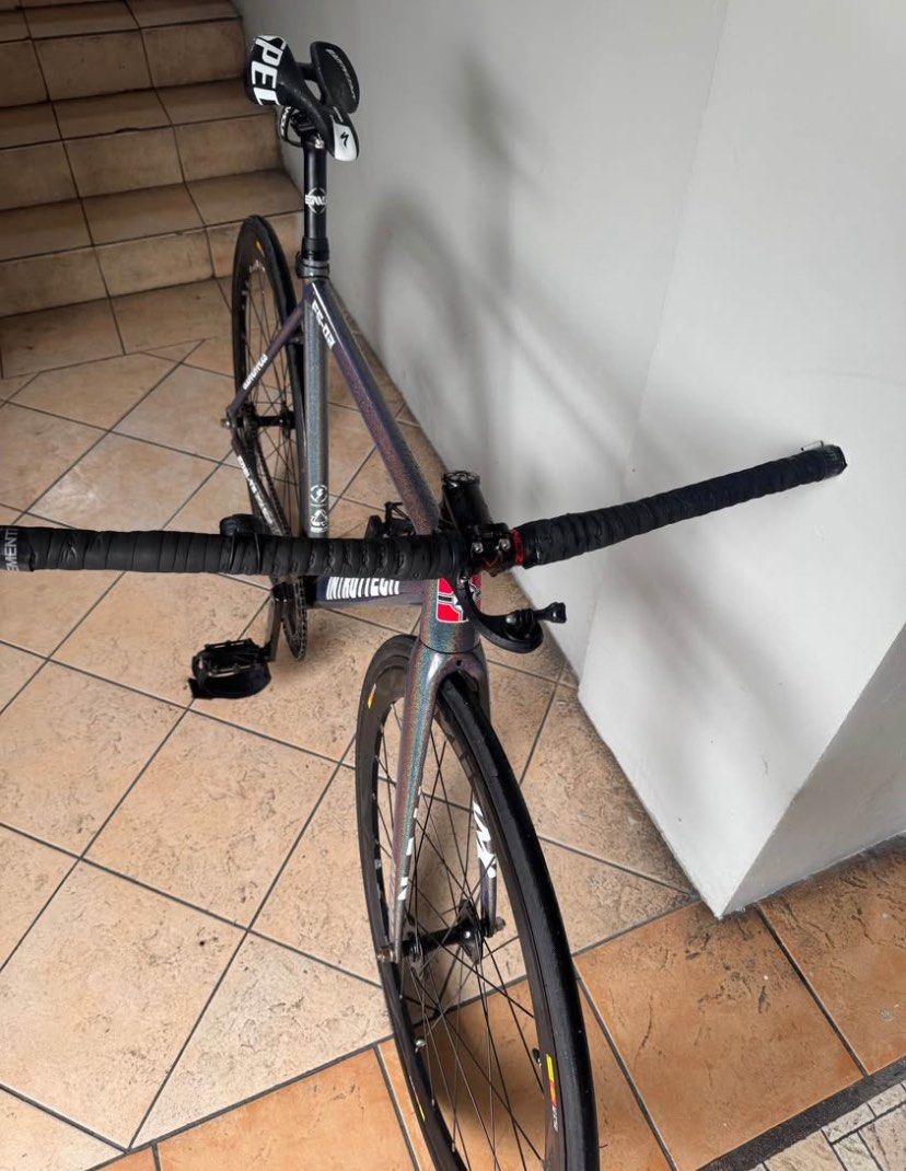 Intro7 FS-02 Fixed Gear Track Bike (Category: Bicycles) located in Manila. Submitted by remotorose29730 (Listing ID 1471248331, Image 3). Description: - Brand/Model: Intro7 FS-02 Track Bike - Frame: 6061-T6 triple-butted alloy in iridescent finish - Crankset: Custom Roman numeral chainring with Pizz & Co cranks - Wheelset: Deep dish with Cosmic SLRs - Cockpit: Flat handlebars with black tape wraps and pedal straps - Seat & Post: ENVE seatpost wit