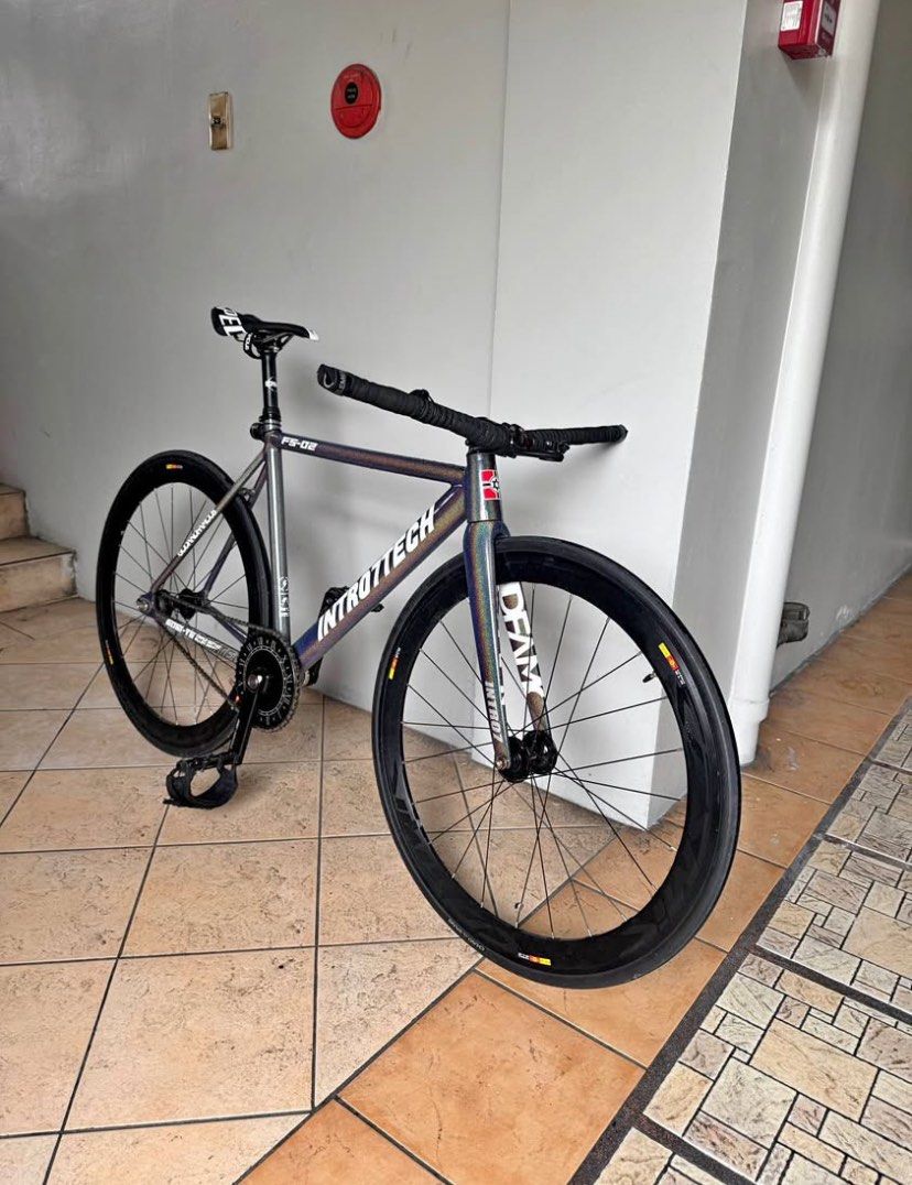 Intro7 FS-02 Fixed Gear Track Bike (Category: Bicycles) located in Manila. Submitted by remotorose29730 (Listing ID 1471248331, Image 1). Description: - Brand/Model: Intro7 FS-02 Track Bike - Frame: 6061-T6 triple-butted alloy in iridescent finish - Crankset: Custom Roman numeral chainring with Pizz & Co cranks - Wheelset: Deep dish with Cosmic SLRs - Cockpit: Flat handlebars with black tape wraps and pedal straps - Seat & Post: ENVE seatpost wit
